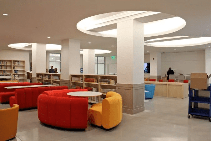 Interior view of a modern library hall with bookshelves and seating areas.